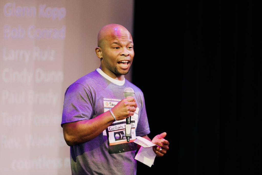 man speaking on stage